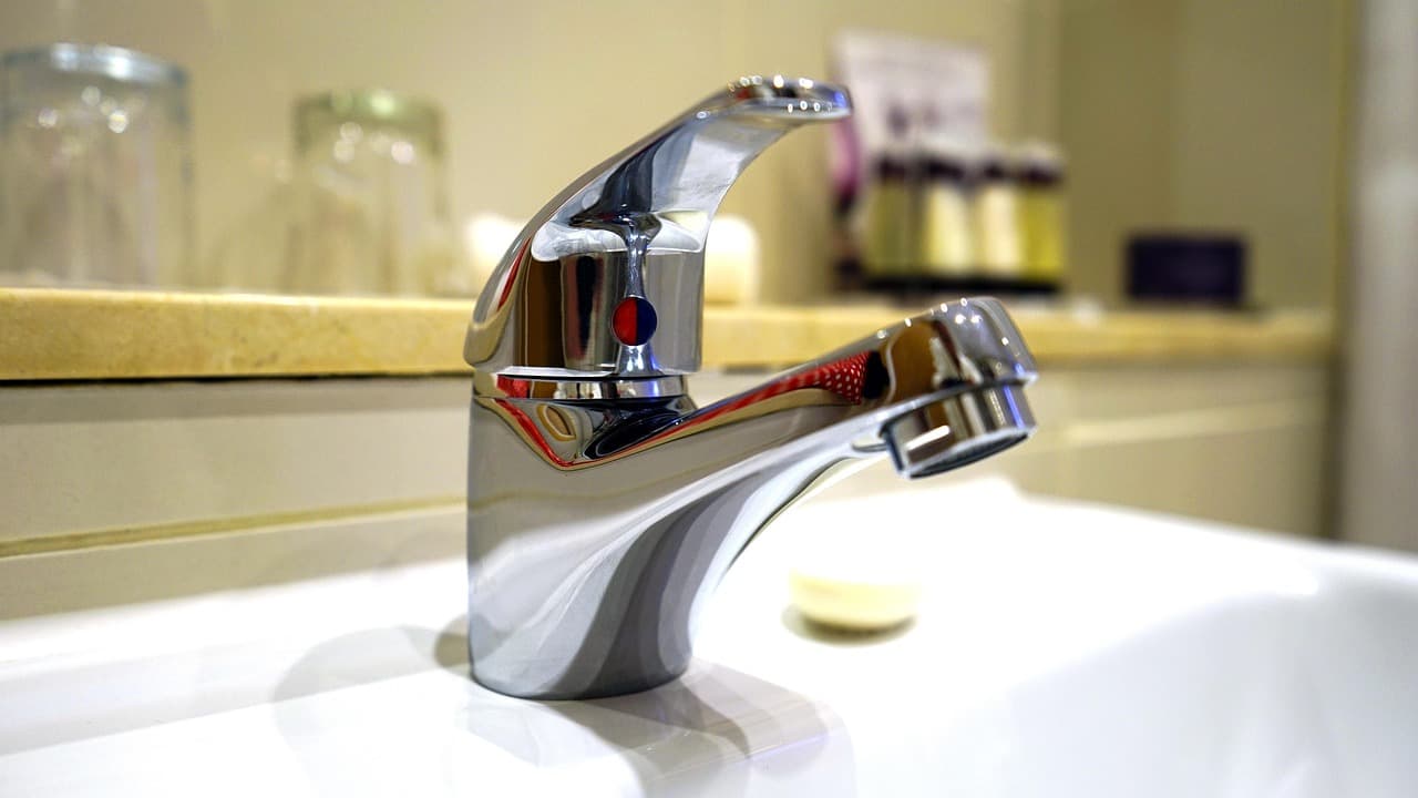 A chrome mixer tap on a white bathroom basin